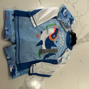 New with tags. 3 piece swim set. Tommy Bahama size 3T.